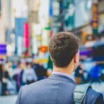 shallow focus photography of man in suit jacket's back